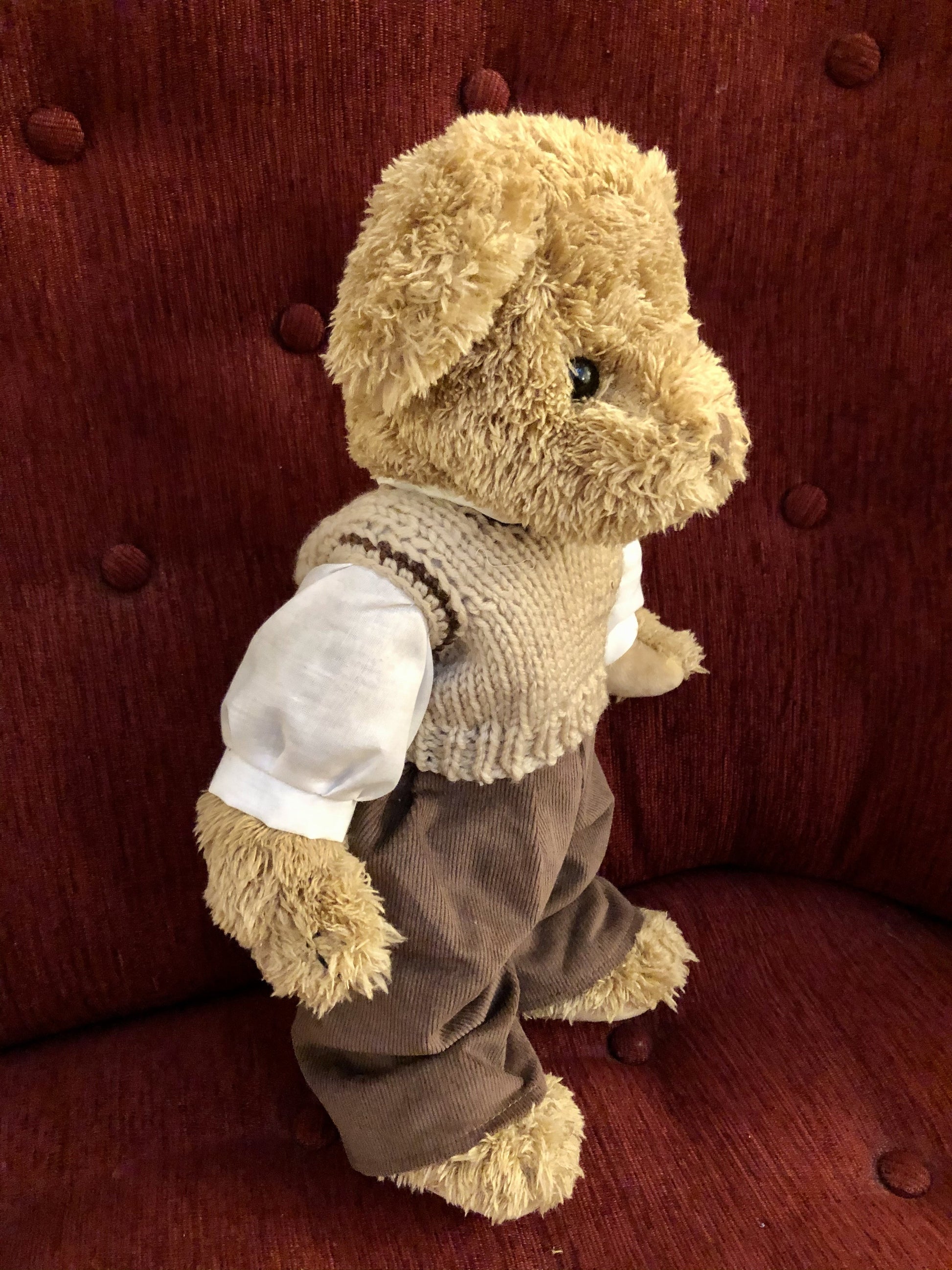 Sweet brown jointed teddy with cord trousers and knitted tank top. 40cm in height.

 

