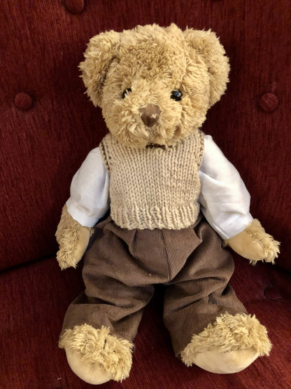 Sweet brown jointed teddy with cord trousers and knitted tank top. 40cm in height.

 

